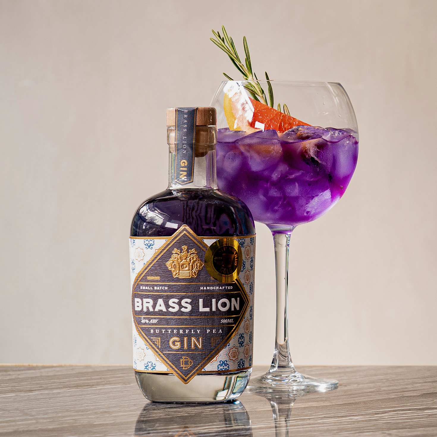 Brass Lion Butterfly Pea Gin with tonic and garnishes in a balloon glass