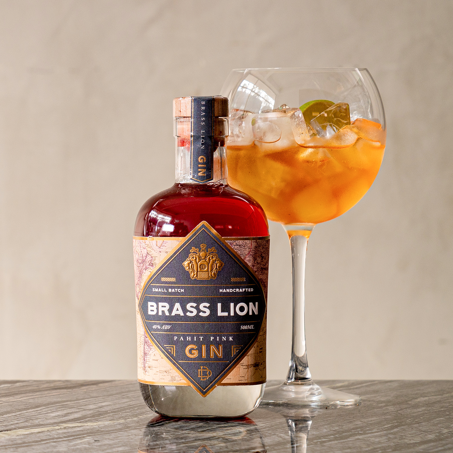 Brass Lion Pahit Pink Gin with signature cocktail served in a globe glass on marble surface